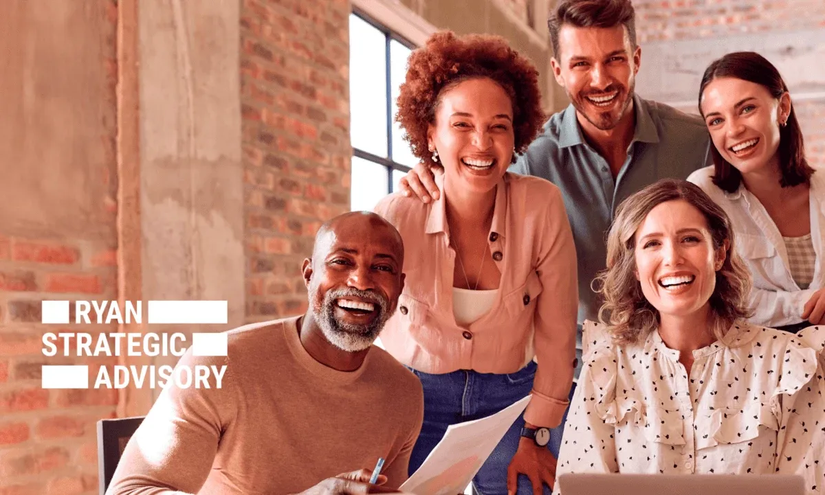 Smiling coworkers looking at camera while working in an industrial style office Smiling coworkers looking at camera while working in an industrial style office