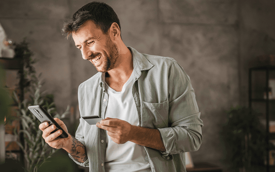 Debt Collections case study cover depicting a smiling man holding his cellphone and his credit card Debt Collections case study cover depicting a smiling man holding his cellphone and his credit card