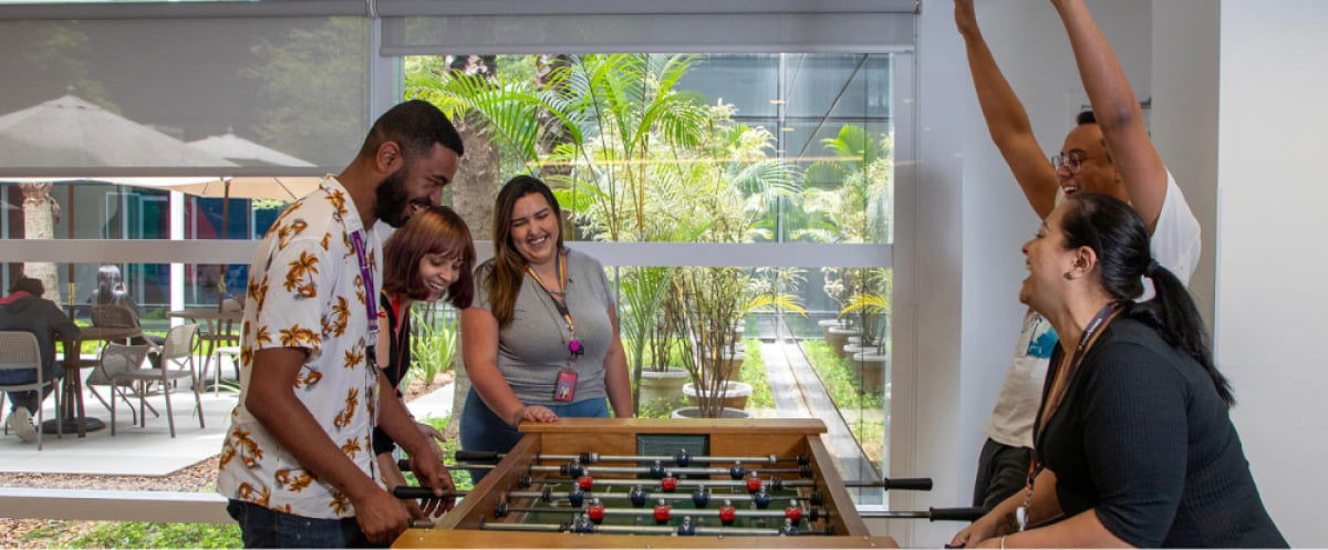 Brazilian employees have fun playing table football  Brazilian employees have fun playing table football