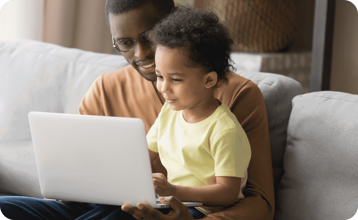 Father and son browsing the web safely on a laptop Father and son browsing the web safely on a laptop