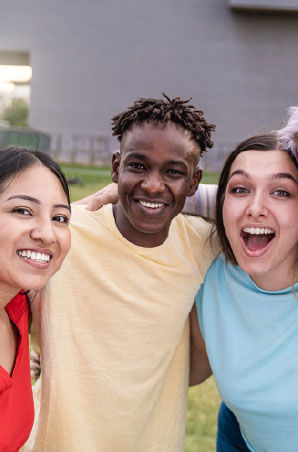 Group of friends hugging each other and smiling Group of friends hugging each other and smiling